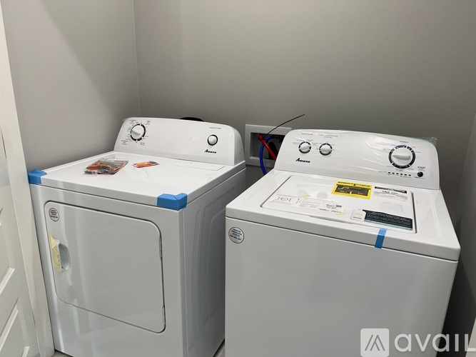 Two front loading washing machines are side by side.