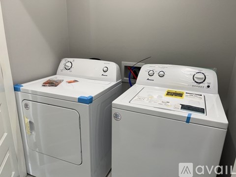 Two front loading washing machines are side by side.