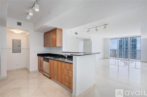 A kitchen with wooden cabinets and a black countertop.