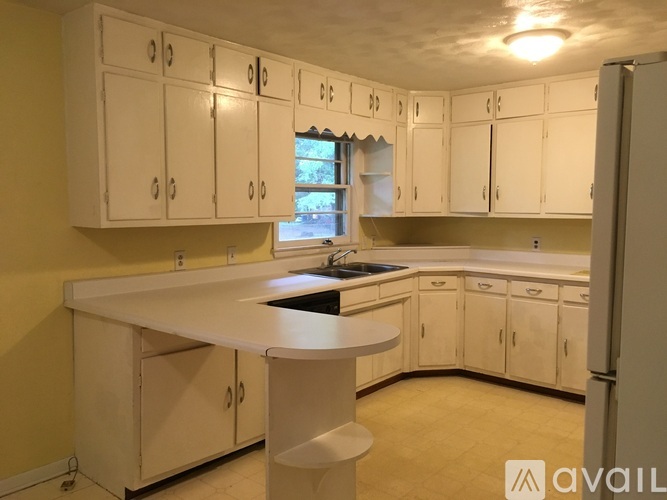 A kitchen with white cabinets and a central island.