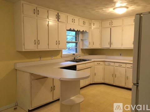 A kitchen with white cabinets and a central island.