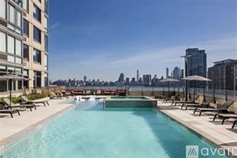 A swimming pool with a city skyline in the background.
