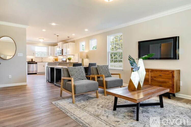 A living room with a grey sofa and a wooden coffee table.