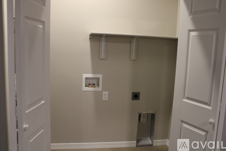A bathroom with a toilet brush and a towel rack.