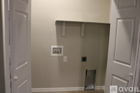 A bathroom with a toilet brush and a towel rack.