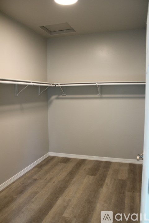 Empty room with wooden floor and white walls.