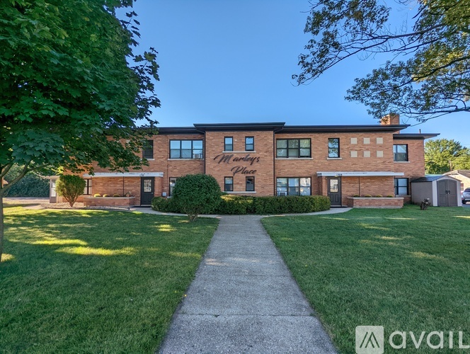 A brick house with a sign that says "Morgan's Plate" on the front.
