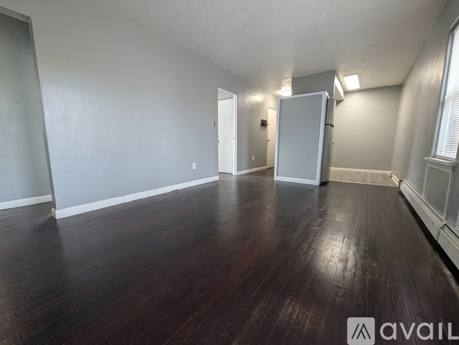 A room with wooden floors and white walls.