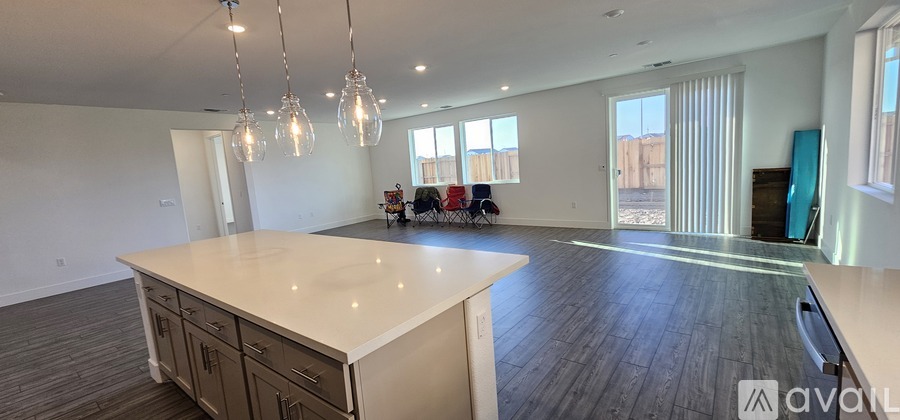 A spacious living room with a white countertop and wooden flooring.