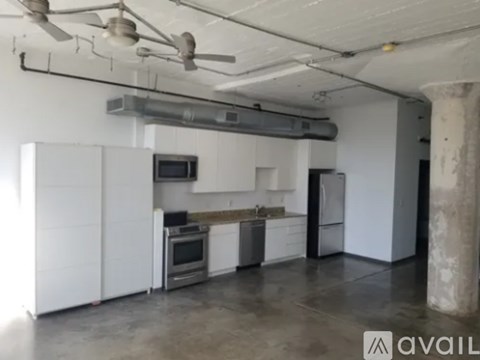A kitchen with white cabinets and stainless steel appliances.