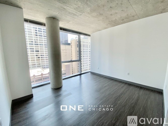 A spacious room with a view of the city through the windows.