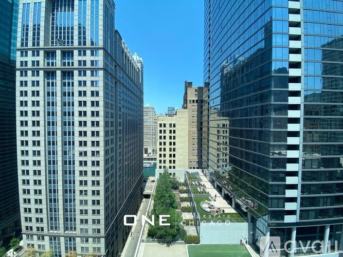 A view of a cityscape with tall buildings and a clear blue sky.