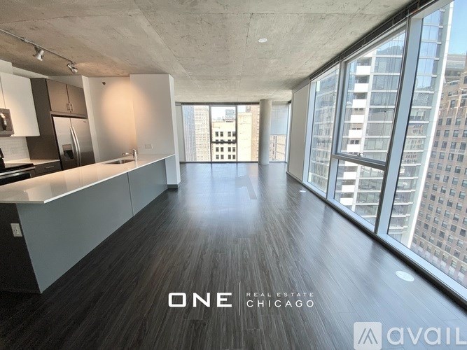 A spacious, empty room with a view of the city skyline.