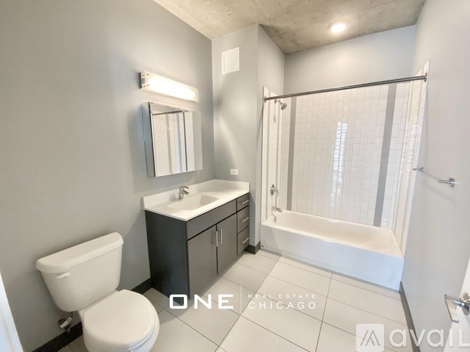 A bathroom with a toilet, sink, and bathtub.