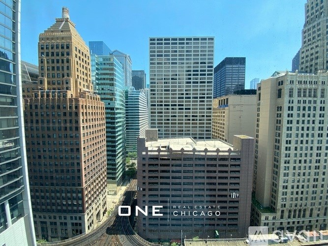 A view of a cityscape with the words "ONE CHICAGO" on a building.