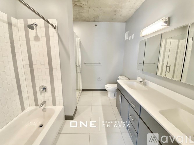 A bathroom with a white tub, sink, and toilet.