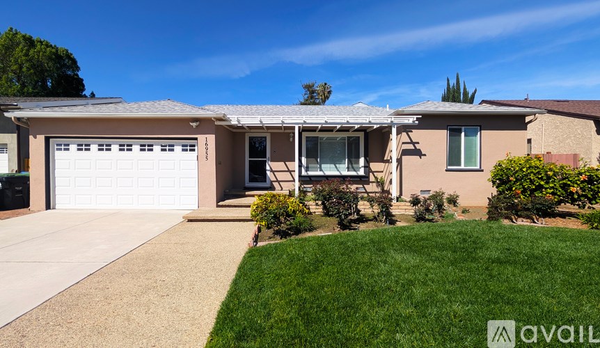 A house with a garage and a driveway is for sale.