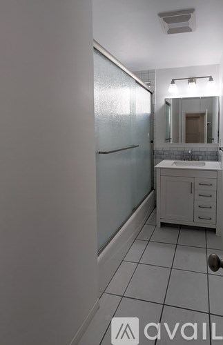 A bathroom with a white sink and a white cabinet.