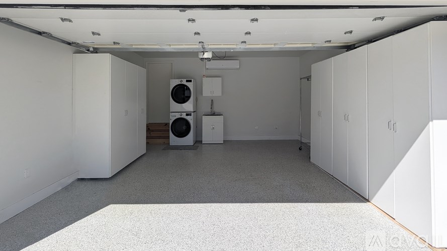 A room with a washing machine and dryer in it.