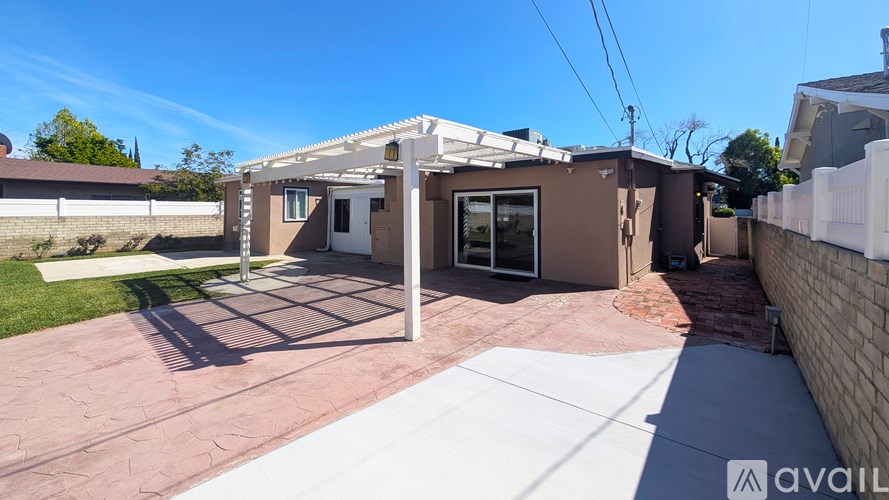 A house with a patio and a white fence.