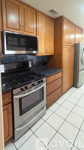 A kitchen with a stove top oven and a microwave above it.