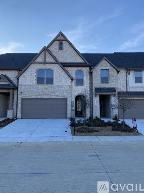 A two-story house with a garage is available for sale.
