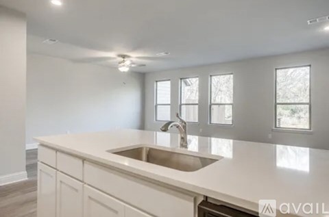 A kitchen with a sink and a window.