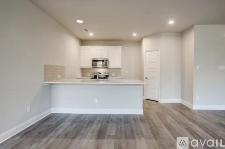 A kitchen area with a counter and cabinets is available.