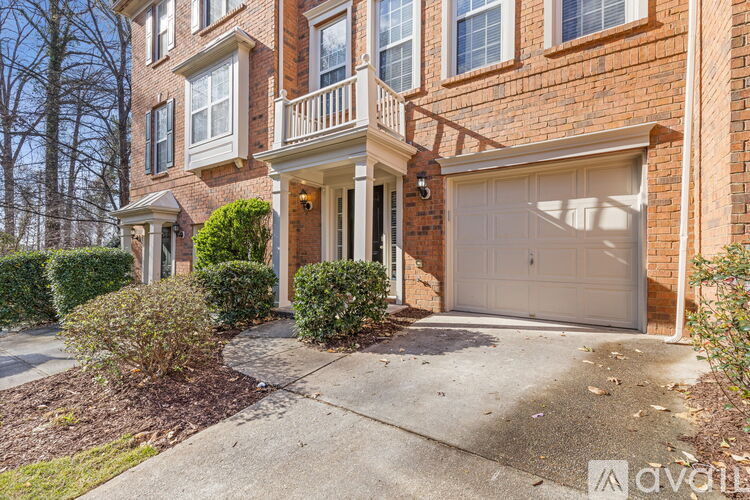A brick house with a garage door that is currently open.