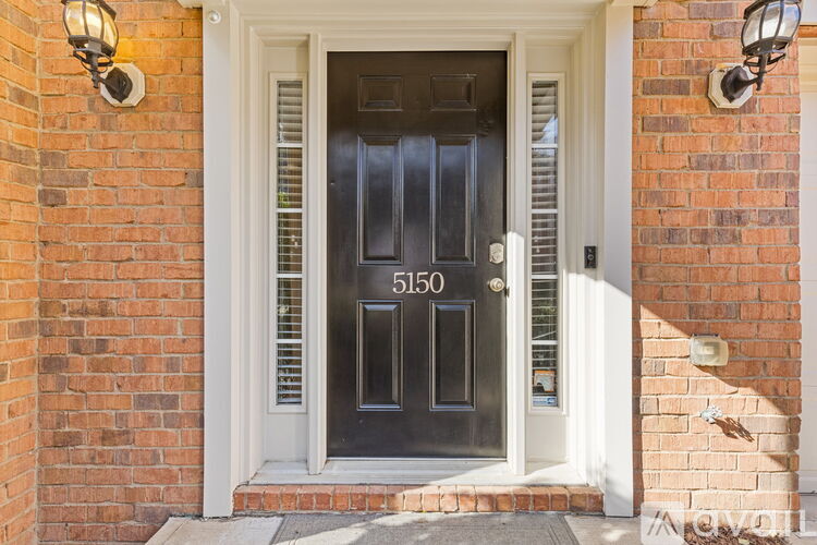 A black door with the number 5150 on it.