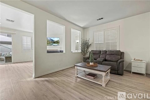 A living room with a couch, chair, and a coffee table.