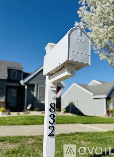 A white US Mail mailbox with the number 832 on it.