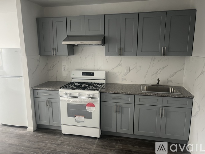 A kitchen with a white oven and sink.