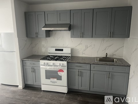 A kitchen with a white oven and sink.