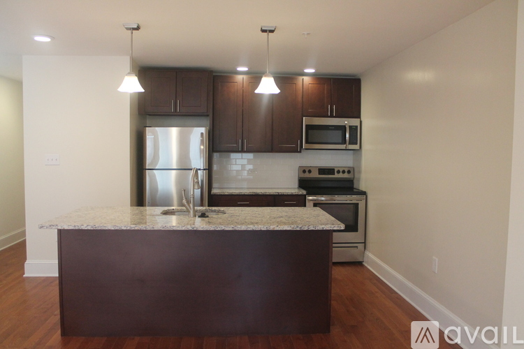 A kitchen with a brown island in the middle.