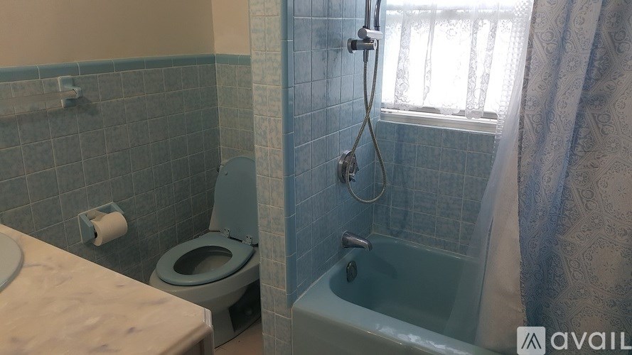 A bathroom with a toilet, sink, and bathtub.