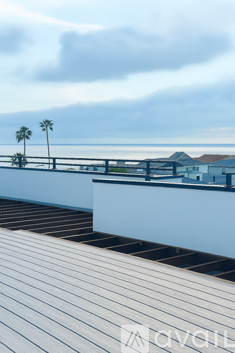 A dining room with a glass table and chairs, a ceiling fan, and a view of the city.