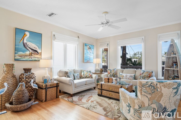 A living room with a painting of a stork on the wall.