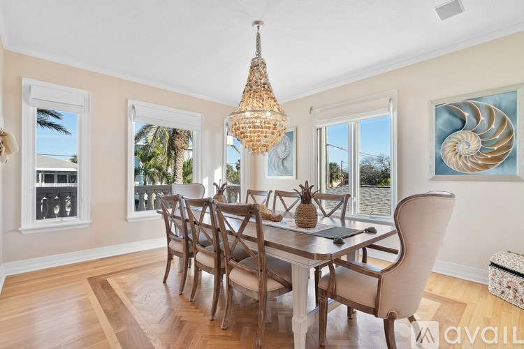 A dining room with a wooden table and chairs.