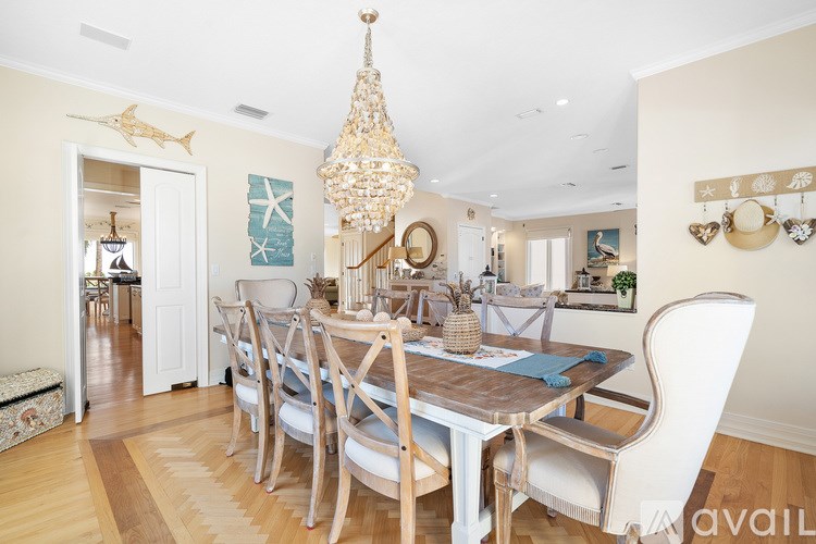 A dining room with a wooden table and chairs.