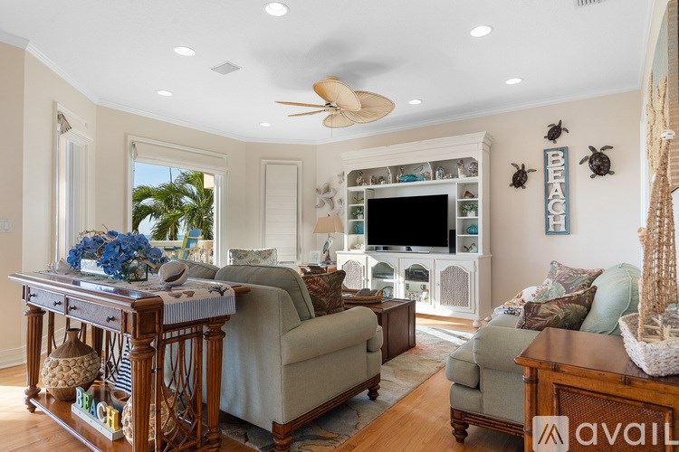 A living room with a couch, a table, and a television.