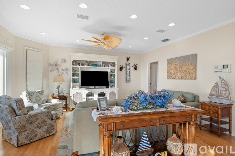 A living room with a white ceiling and a wooden table.