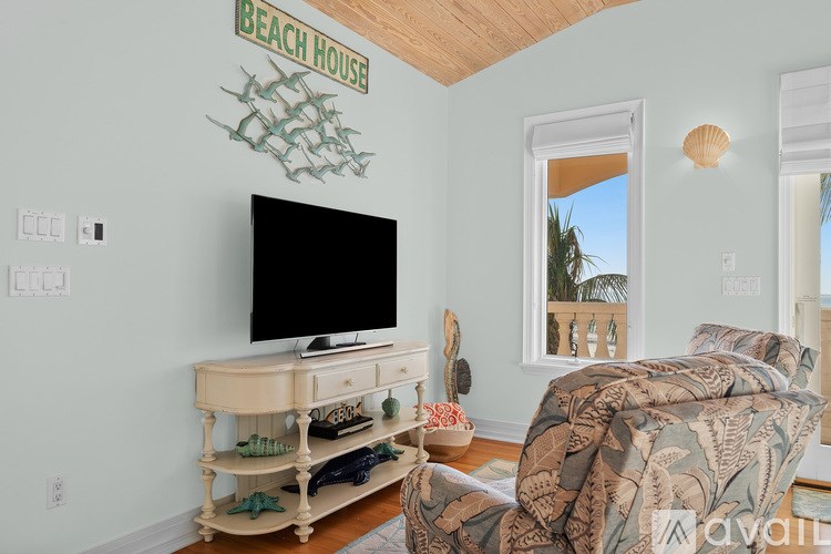 A living room with a television and a couch.