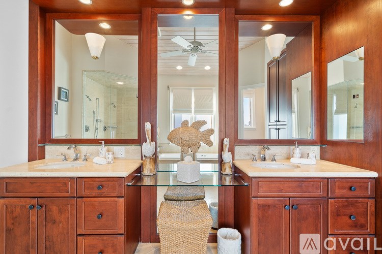 A bathroom with two sinks and a large mirror.