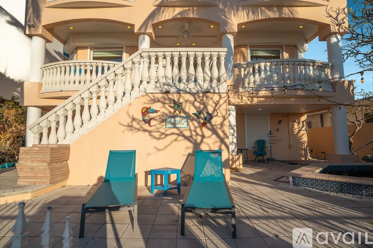 A large house with a balcony and a pool.