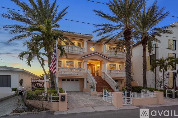A house with a flag on the front lawn.