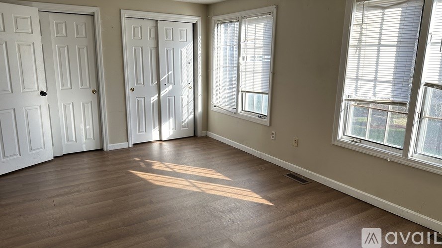 A room with two doors and two windows.