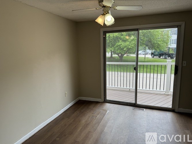 A room with a sliding glass door leading to a deck.