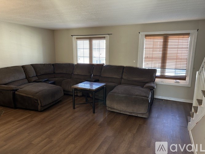 A living room with a large sectional sofa and a coffee table.