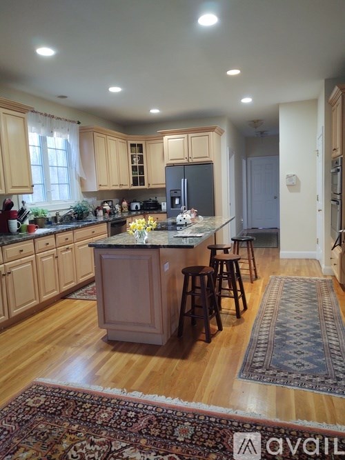 A kitchen with wooden cabinets and a central island.